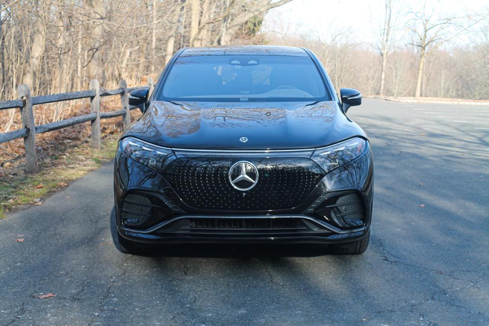 The front grille area of a black 2023 Mercedes-Benz EQS SUV.