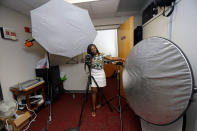 <p>Briana Lawrence, 21, works on her lighting skills in a photo and video studio at North Carolina Central University in Durham, N.C., on Thursday, July 14, 2016. With $40,000 in student debt, she’s working hard to establish her own cosmetic business after graduating. She plans to vote for Hillary Clinton, but feels America has lost its way. (AP Photo/Gerry Broome) </p>