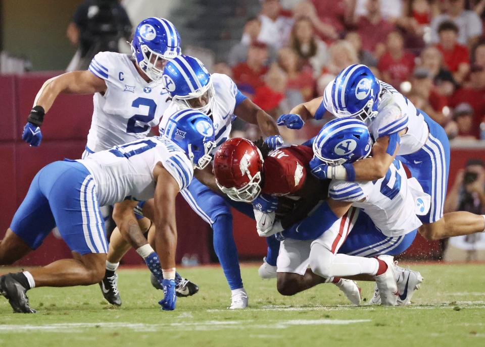 BYU Cougars defense tackles Arkansas Razorbacks wide receiver Andrew Armstrong (2) at Razorback Stadium in Fayetteville on Saturday, Sept. 16, 2023. | Jeffrey D. Allred, Deseret News