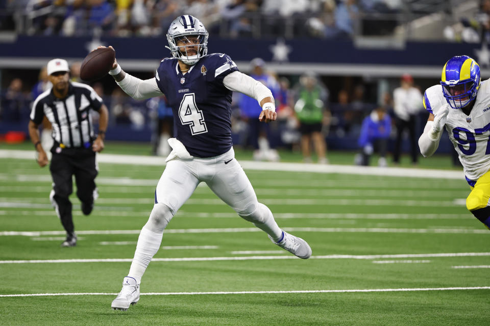 Dallas Cowboys quarterback Dak Prescott (4) throws a touchdown pass to wide receiver CeeDee Lamb during the first half of an NFL football game against the Los Angeles Rams, Sunday, Oct. 29, 2023, in Arlington, Texas. (AP Photo/Roger Steinman)