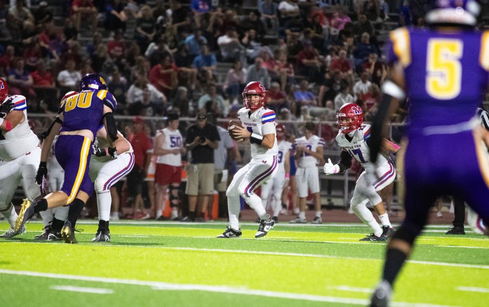 Mountain View quarterback Jack Germaine looks for an opening on Oct. 5, 2023, at Mesa High School football stadium.