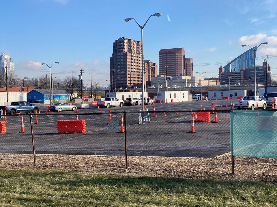 A dozen vehicles wait in two lines at the Gravity Diagnostics COVID-19 drive-thru testing site in downtown Covington, Ky. on Tuesday morning, Jan. 25, 2022. A few weeks ago, lines stretched for blocks outside the site with vehicles holding people waiting for tests and more lines crowded the lot.