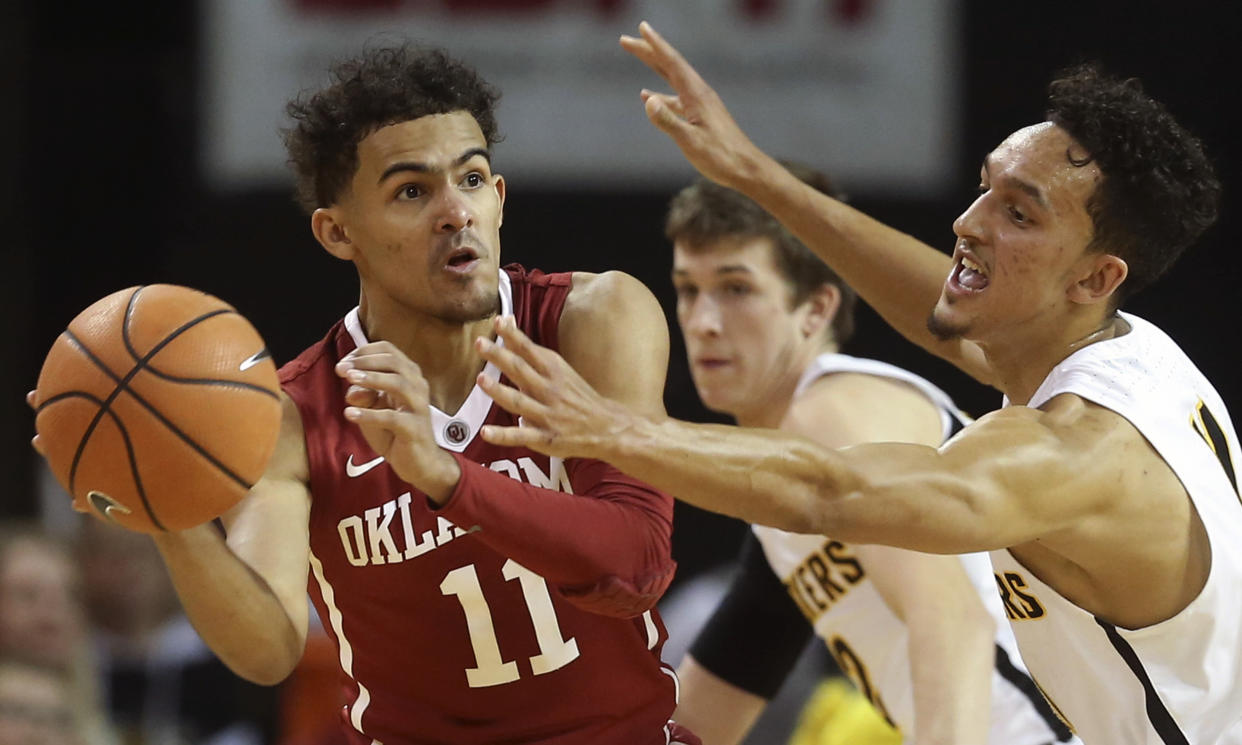 Oklahoma guard Trae Young (L) looks for a pass while Wichita State guard Landry Shamet defends. (Travis Heying/The Wichita Eagle via AP)