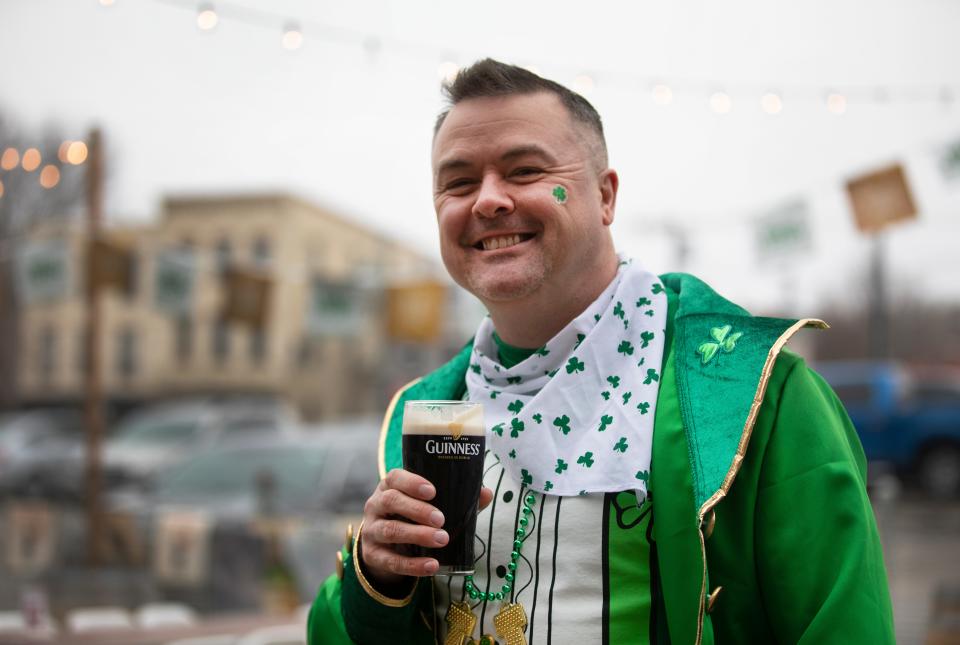 Brad Wilson, of Dayton, Ohio, enjoys a Guinness in all his finery as he celebrates St. Patrick's Day with friends.