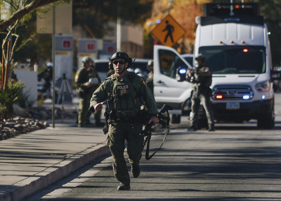 A police officer works the scene of a shooting on the University of Nevada, Las Vegas campus on Wednesday, Dec. 6, 2023, in Las Vegas. (Madeline Carter/Las Vegas Review-Journal via AP)