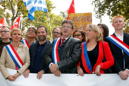 Politician Jean-Luc Melenchon (C), member of parliament from La France Insoumise political party (France Unbowed) stands with Benoit Hamon (2ndL), former political presidential candidate and head of "Mouvement du 1er juillet" (First of July movement) and Clementine Autain (L) as they attend a demonstration against the government's labour reforms in Paris, France, September 23, 2017. REUTERS/Philippe Wojazer