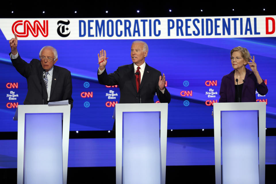 Democratic presidential candidate Sen. Bernie Sanders, I-Vt., left, former Vice President Joe Biden, center, and Sen. Elizabeth Warren, D-Mass., raise their hands to speak during a Democratic presidential primary debate hosted by CNN/New York Times at Otterbein University, Tuesday, Oct. 15, 2019, in Westerville, Ohio. (AP Photo/John Minchillo)