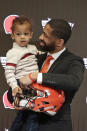 Cleveland Browns general manager Andrew Berry holds his two-year old son, Zion, after speaking at a news conference at the NFL football team's training facility, Wednesday, Feb. 5, 2020, in Berea, Ohio. Berry returned to the team after a one-year stint in the Philadelphia Eagles' front office. Berry was the Browns' vice president of player personnel from 2016-18. (AP Photo/Tony Dejak)