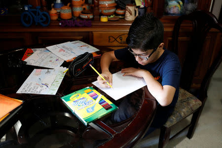 Gabriel Moncada draws at his home in Caracas, Venezuela October 15, 2018. REUTERS/Marco Bello