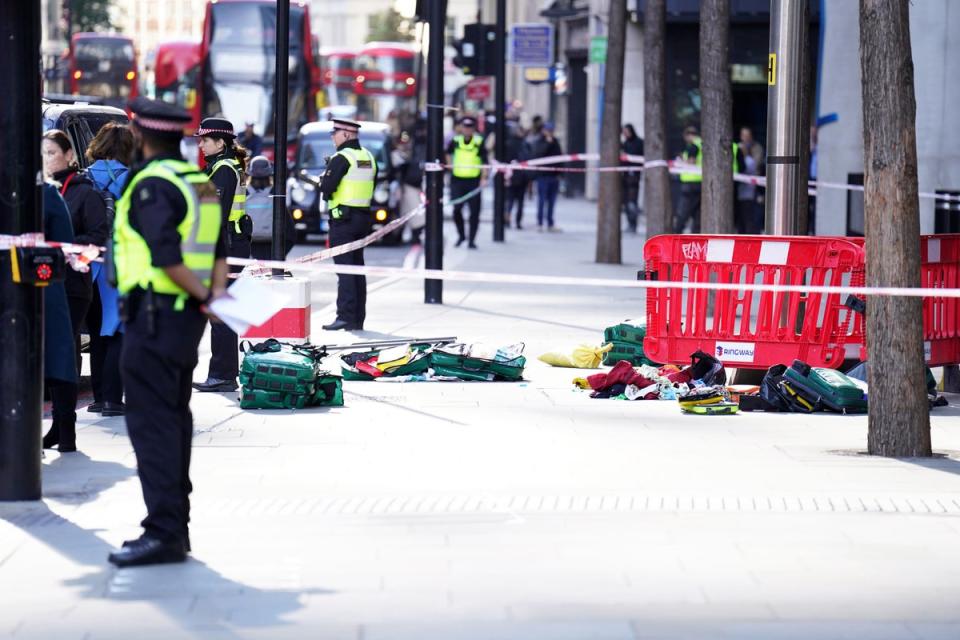 Police officers at the scene after three people were taken to hospital following an attempted phone robbery in Bishopsgate (PA Wire)