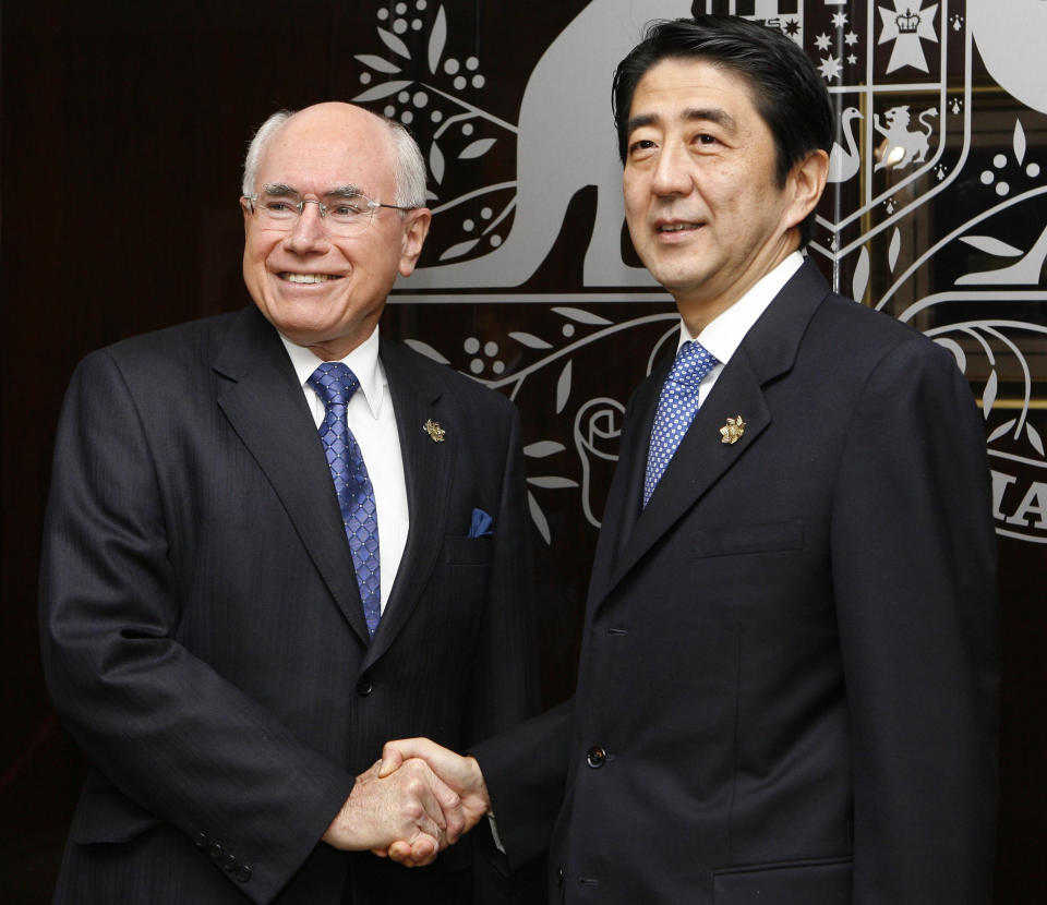 FILE - Japanese Prime Minister Shinzo Abe, right, is welcomed by his Australian counterpart John Howard at Howard's office in Sydney, Australia, on Sept. 8, 2007. Australia will be represented by its government leader plus three former leaders at Abe’s state funeral this month in an extraordinary mark of respect for Japan’s longest-serving prime minister. Prime Minister Anthony Albanese said on Thursday, Sept. 8, 2022, that former Prime Ministers Howard, Tony Abbott and Malcolm Turnbull would join Australia’s official delegation. (AP Photo/Toru Yamanaka, Japan Pool)