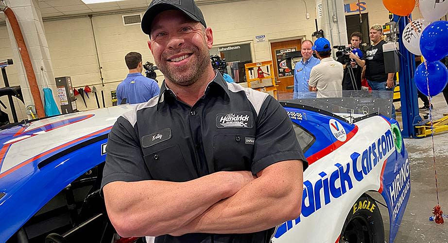 Kelly Brandt smiles for a photo on the shop floor of the auto tech department at Hanahan (S.C.) High School