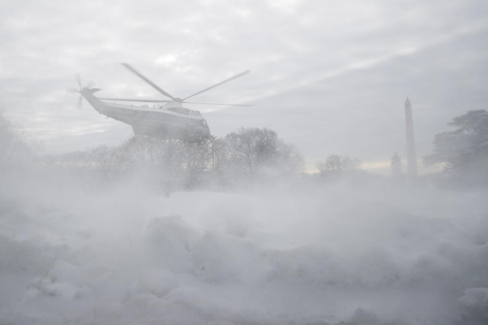 Snow is kicked up by the prop wash as Marine One carrying President Donald Trump departs the South Lawn of the White House, Monday, Jan. 14, 2019, in Washington. (AP Photo/ Evan Vucci)