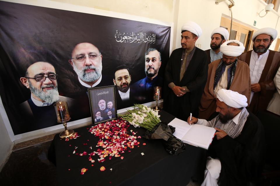 A visitor signs a condolence book at the Khana-e-Farhang Iranian culture centre following the deaths of Iran's president Raisi and Foreign Minister Amir-Abdollahian, in Peshawar, Pakistan (EPA)