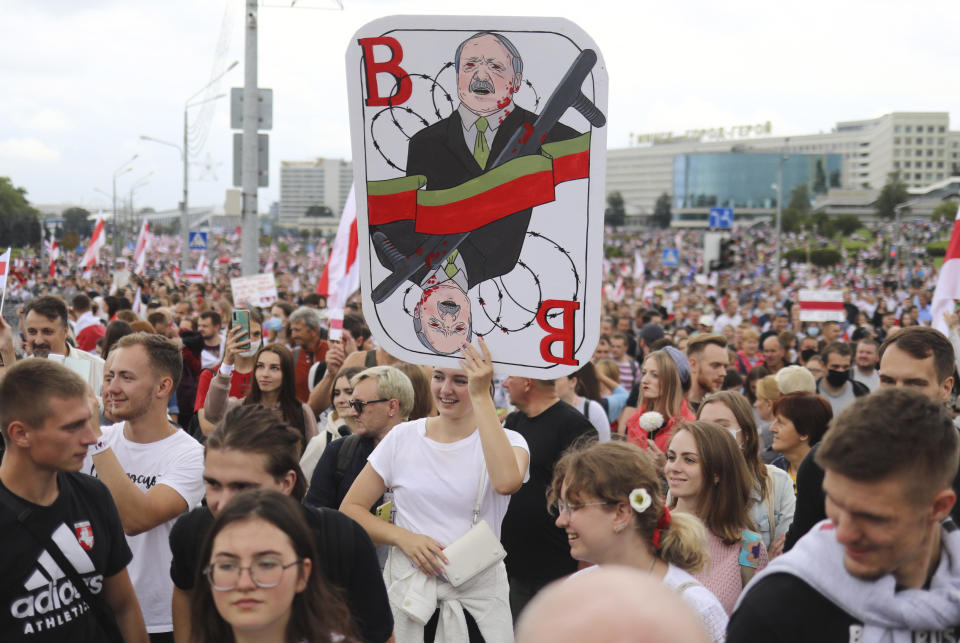 A woman holds a caricature of Belarus President Alexander Lukashenko during an opposition rally to protest the official presidential election results in Minsk, Belarus, Sunday, Sept. 6, 2020. Sunday's demonstration marked the beginning of the fifth week of daily protests calling for Belarusian President Alexander Lukashenko's resignation in the wake of allegedly manipulated elections. (AP Photo/TUT.by)