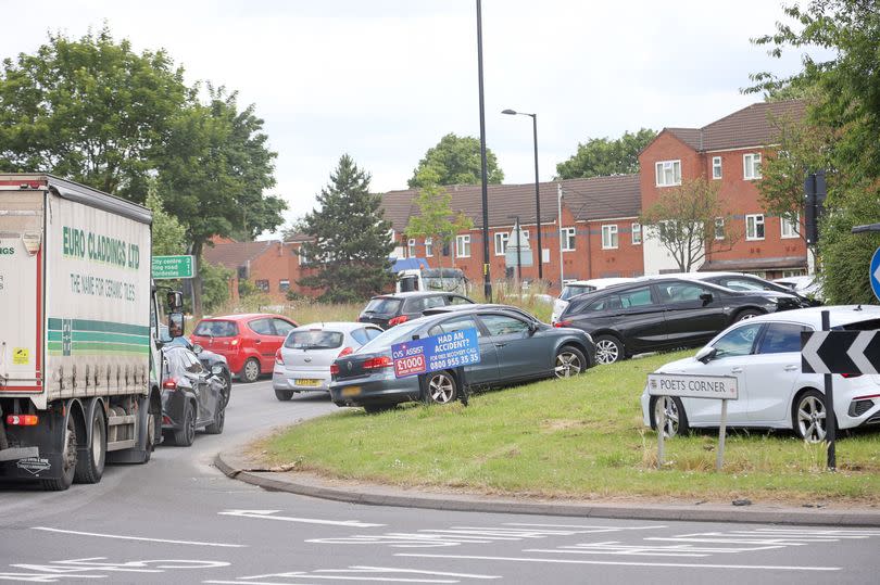 Cars parked on Poets Corner roundabout at Small Heath.