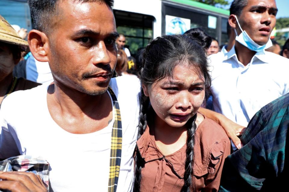 A prisoner, left, is welcomed by family members and colleagues after he was released Insein Prison in Yangon, Myanmar (AP)