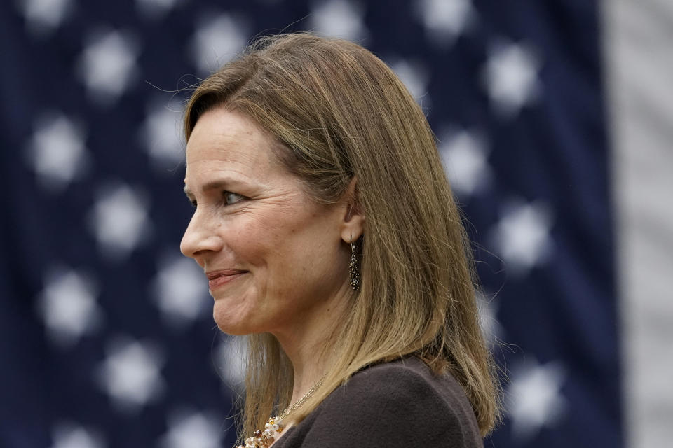 Judge Amy Coney Barrett listens as President Donald Trump announces Barrett as his nominee to the Supreme Court, in the Rose Garden at the White House, Saturday, Sept. 26, 2020, in Washington. (AP Photo/Alex Brandon)