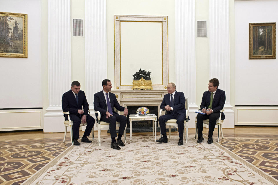 Russian President Vladimir Putin, second right, speaks to Syrian President Bashar Assad during their meeting in the Kremlin in Moscow, Russia, Monday, Sept. 13, 2021. (Mikhail Klimentyev, Sputnik, Kremlin Pool Photo via AP)