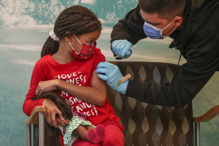 Arcadia, CA - January 08: Pedro Elizarraraz, a RN, gives Amelle Samuel, 7, first dose of Pfizer-BioNtech Covid-19 vaccine at Children's Hospital Arcadia Speciality Care Center on Saturday, Jan. 8, 2022 in Arcadia, CA. (Irfan Khan / Los Angeles Times)