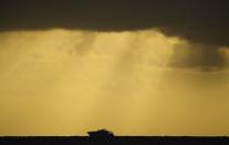 A boat is seen on the horizon just before the start of the total solar eclipse.