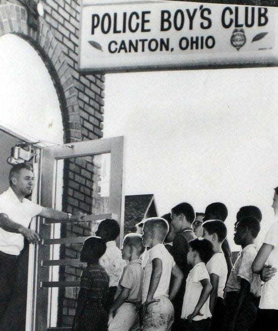 Canton Policeman J. Babe Stearn, left, enthusiastically welcomed youngsters to the Canton Police Boys Club on Navarre Road SW during his tenure as director. According to one individual who used the club, it was, among other things, a place to learn boxing, compete in basketball, bowl on lanes in the basement, learn arts and crafts, shoot archery and play pool.