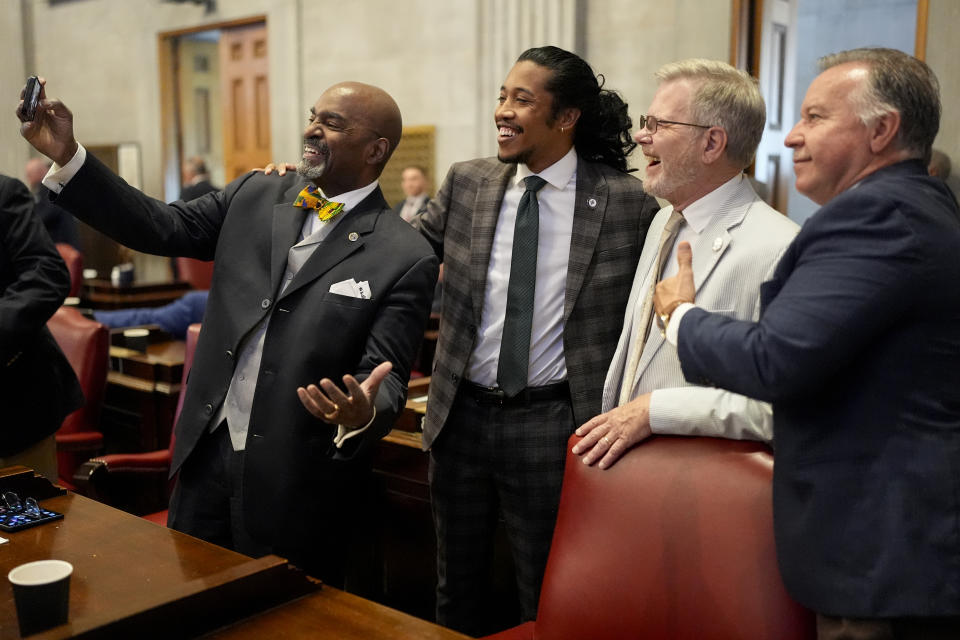 Rep. G.A. Hardaway, D-Memphis, far left, takes a picture with Rep. Justin Jones, D-Nashville, center left, Rep. Dwayne Thompson, D-Cordova, center right, and Rep. Mike Sparks, R-Smyrna, far right, on the House floor during a legislative session Thursday, April 25, 2024, in Nashville, Tenn. (AP Photo/George Walker IV)