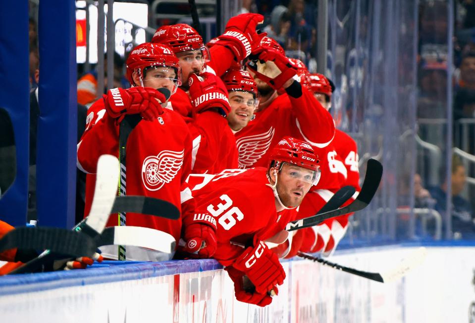 The Red Wings celebrate a third period goal by J.T. Compher against the Islanders during the Wings' 4-3 overtime win on Monday, Oct. 30, 2023, in Elmont, New York.