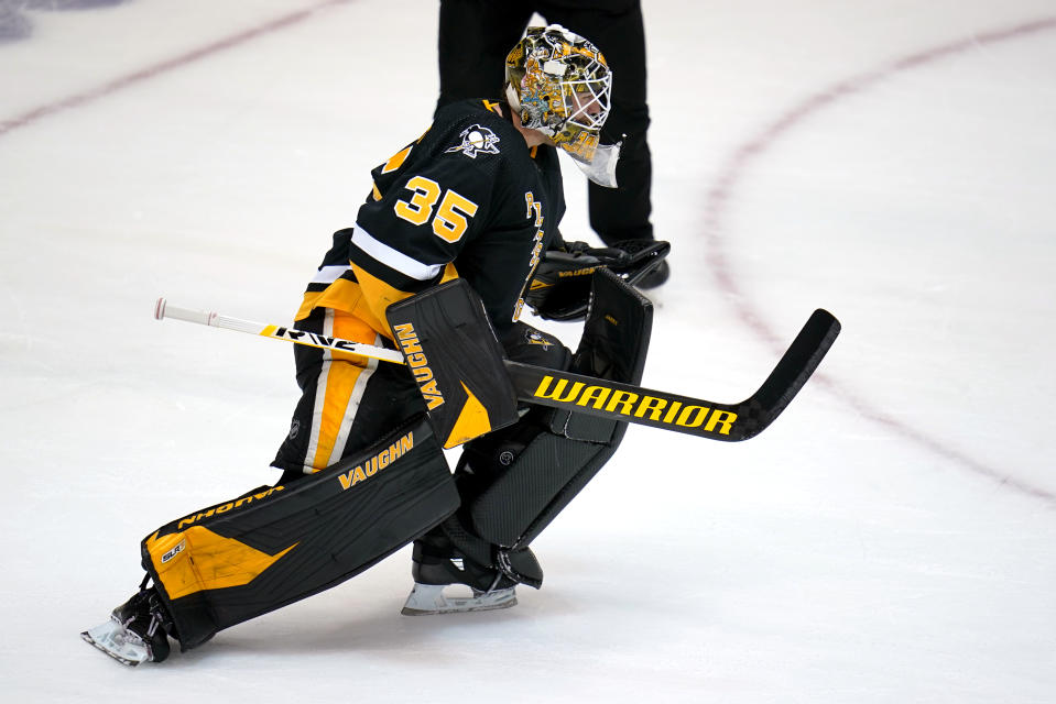 Pittsburgh Penguins goaltender Tristan Jarry begins to celebrate after blocking a shot by Winnipeg Jets' Pierre-Luc Dubois during an NHL hockey game shootout in Pittsburgh, Sunday, Jan. 23, 2022. (AP Photo/Gene J. Puskar)