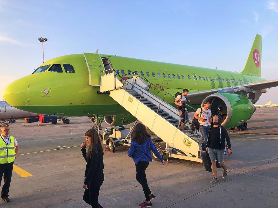 Passengers getting off a S7 plane.