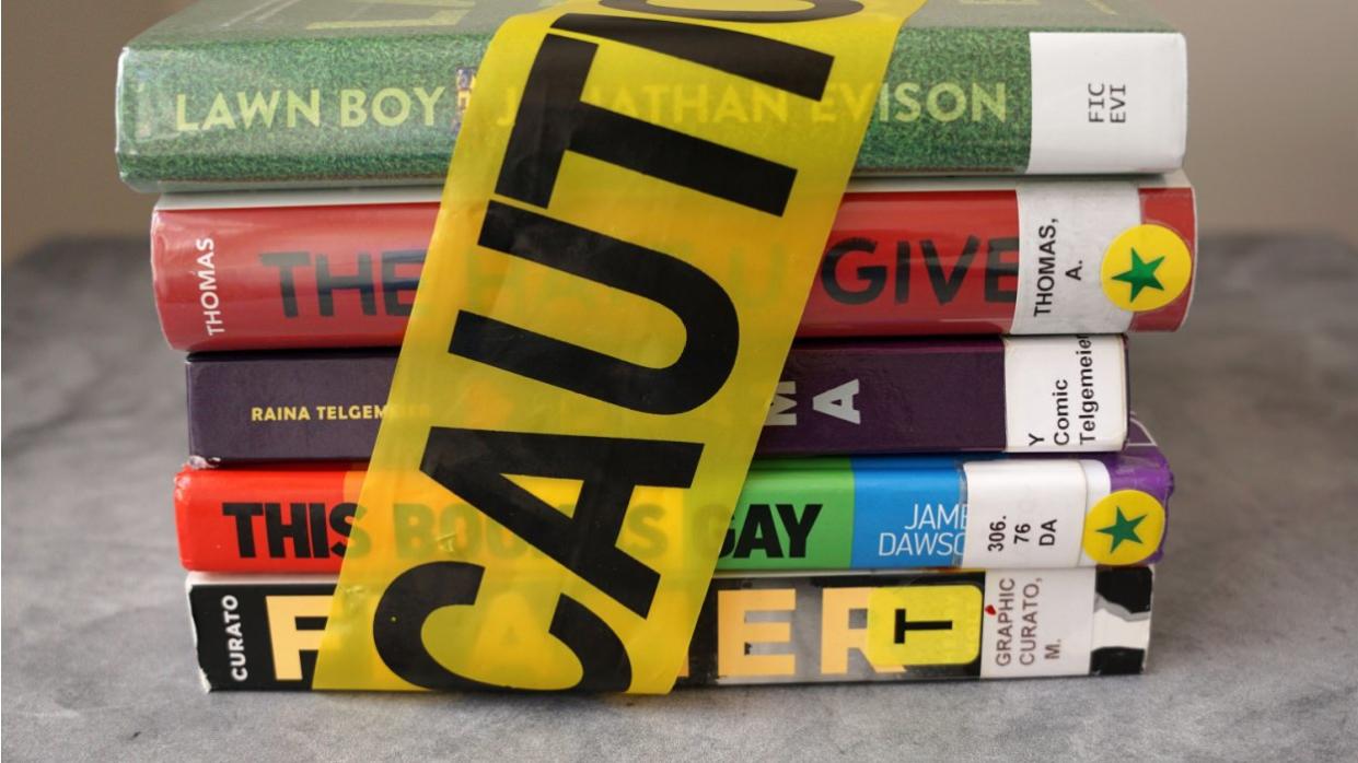 Books wrapped with caution tape that are banned
