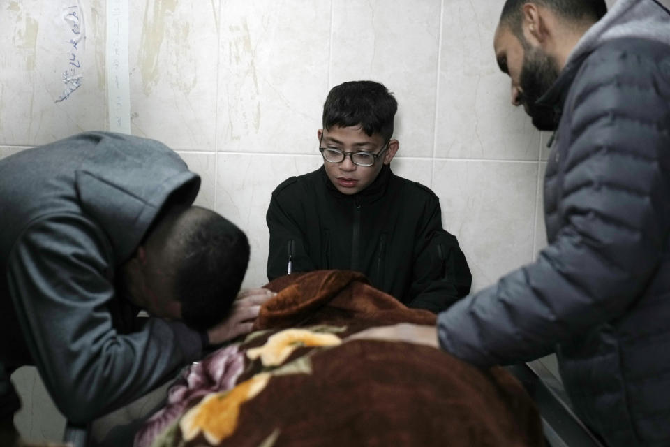 Palestinian mourners bid farewell to one of three men killed by Israeli fire in Faraa refugee camp, at the morgue in the West Bank town of Tubas, Tuesday, Feb. 27, 2024. Israeli troops shot and killed three Palestinian men including Mohammed Daraghmeh, a co-founder of the local branch of Islamic Jihad in the northern town of Tubas, early Tuesday, Palestinian health authorities said. Thee was no immediate comment from the Israeli military. (AP Photo/Majdi Mohammed)