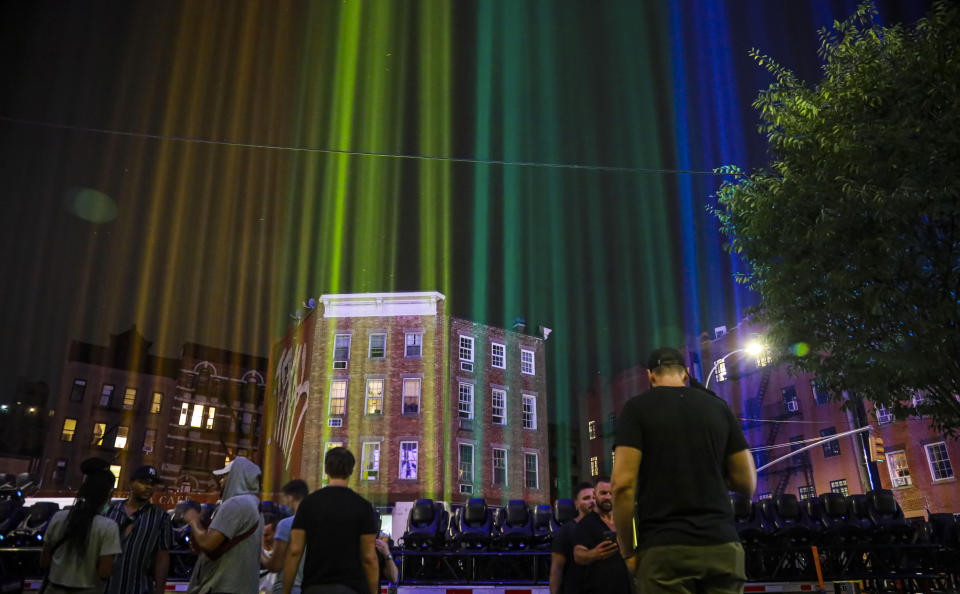 A rainbow light display illuminates the night sky in the West Village neighborhood of New York near The Stonewall Inn, the birthplace of the gay rights movement, on Saturday, June 27, 2020. This year would have been the 50th anniversary of the NYC Pride March, which was canceled because of the coronavirus pandemic. (AP Photo/Bebeto Matthews)