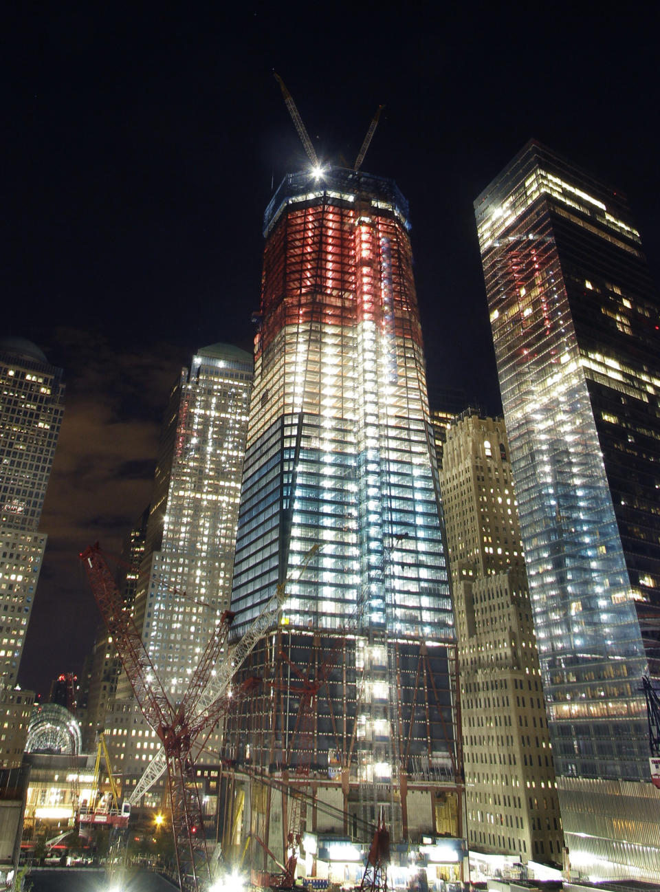 One World Trade Center, center, is illuminated in red, white, and blue prior to the visit of President Barack Obama to the September 11 Memorial, Thursday, May 5, 2011 in New York. Osama bin Laden, the mastermind of the September 11, 2001 attacks, was killed by U.S. forces in Pakistan, May 2, 2011. (AP Photo/Mark Lennihan)