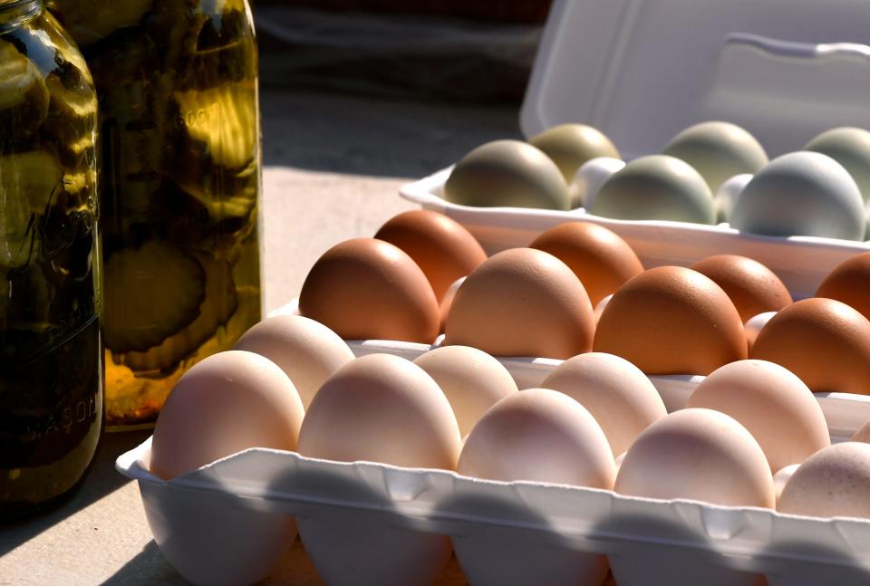 Fresh eggs and pickles catch the morning sun in a stall at the Abilene Farmer's Market Saturday May 14, 2022.