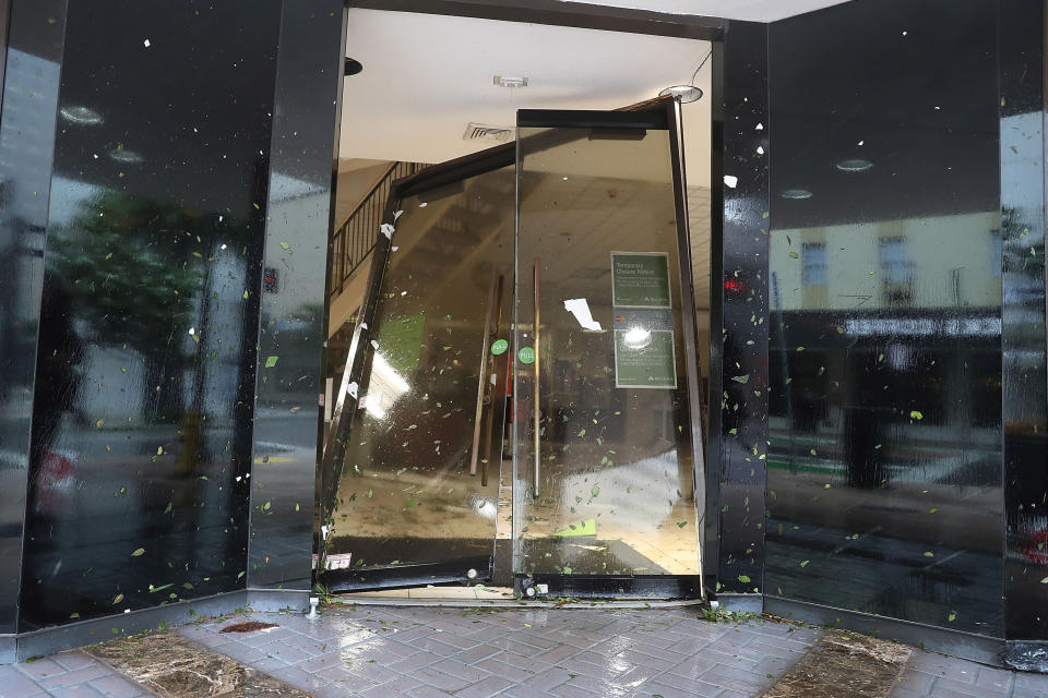 A door is seen blown in at a Regions Bank in Miami, Florida.