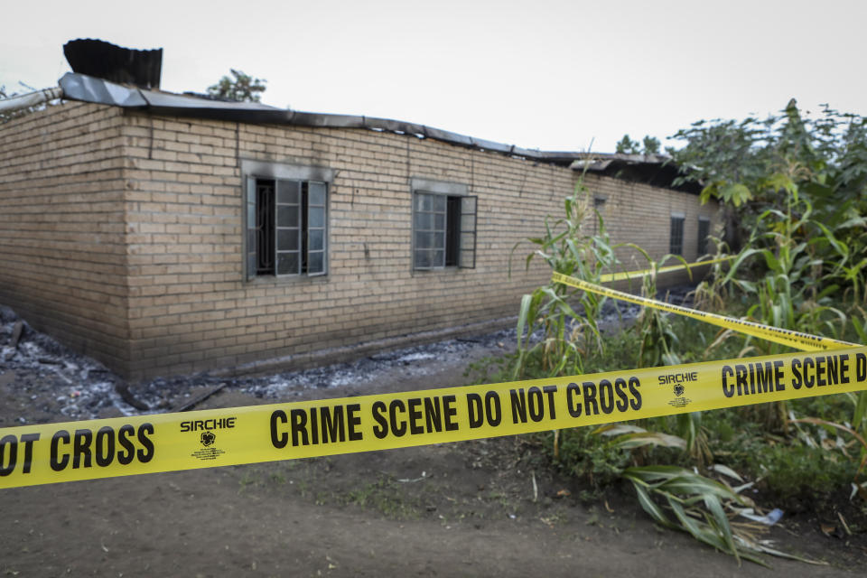 Tape cordons off a building inside the Lhubiriha Secondary School following an attack on the school on Saturday, in Mpondwe, Uganda Sunday, June 18, 2023, near the border with Congo. Ugandan authorities have recovered the bodies of 41 people including 38 students who were burned, shot or hacked to death after suspected rebels attacked the school, according to the local mayor. (AP Photo/Hajarah Nalwadda)