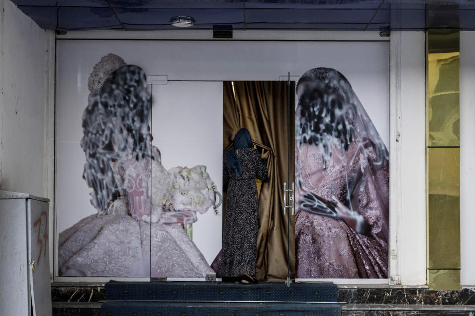 FILE - A woman enters a beauty salon in Kabul, Afghanistan, Saturday, Sept. 11, 2021. A spokesman at Afghanistan's Vice and Virtue Ministry said Tuesday, July 4, 2023, the Taliban are banning women's beauty salons. (AP Photo/Bernat Armangue, File)