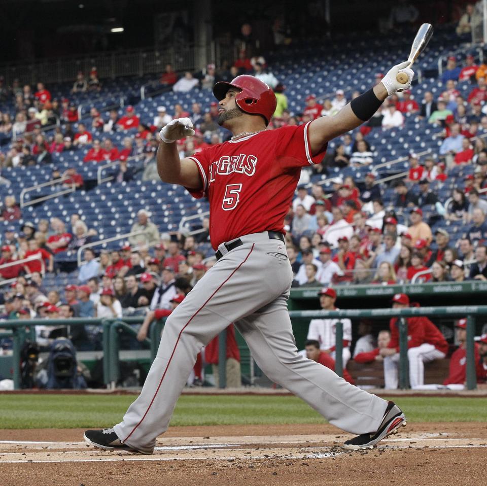 Los Angeles Angels Albert Pujols watches his three-run homer, against Washington Nationals starting pitcher Taylor Jordan, clear the fence during the first inning of a baseball game, Tuesday, April 22, 2014. This was Pujols 499th home run of his career. (AP Photo/Pablo Martinez Monsivais)