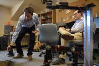 University of Colorado Boulder graduate researcher Mellinkoff sets up an experiment for an assembly robot at a lab