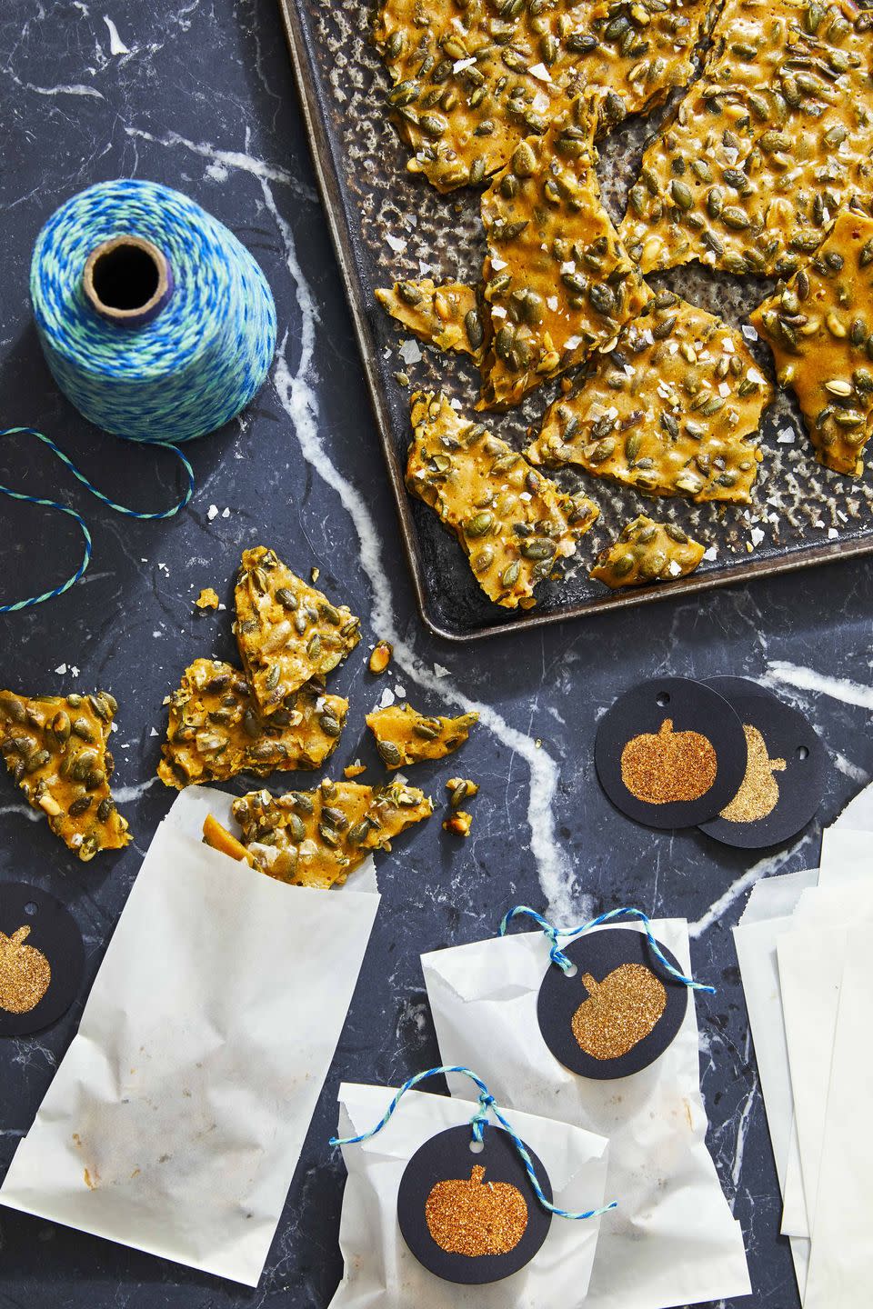 <p>This sweet treat is trickier than your standard kid-friendly fare. Roasted pepitas, herbs, a generous pinch of salt and a dash of pepper give it a spooky mix of flavors.</p><p><strong><a href="https://www.countryliving.com/food-drinks/a33944366/rosemary-pumpkin-seed-brittle/" rel="nofollow noopener" target="_blank" data-ylk="slk:Get the recipe;elm:context_link;itc:0;sec:content-canvas" class="link ">Get the recipe</a>.</strong></p><p><strong><a class="link " href="https://www.amazon.com/Nordic-Ware-Natural-Aluminum-Commercial/dp/B0049C2S32/?tag=syn-yahoo-20&ascsubtag=%5Bartid%7C10050.g.454%5Bsrc%7Cyahoo-us" rel="nofollow noopener" target="_blank" data-ylk="slk:SHOP BAKING SHEETS;elm:context_link;itc:0;sec:content-canvas">SHOP BAKING SHEETS</a><br></strong></p>