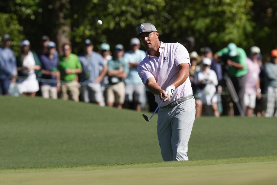 Bryson DeChambeau chips to the green on the eighth hole during third round at the Masters golf tournament at Augusta National Golf Club Saturday, April 13, 2024, in Augusta, Ga. (AP Photo/David J. Phillip)