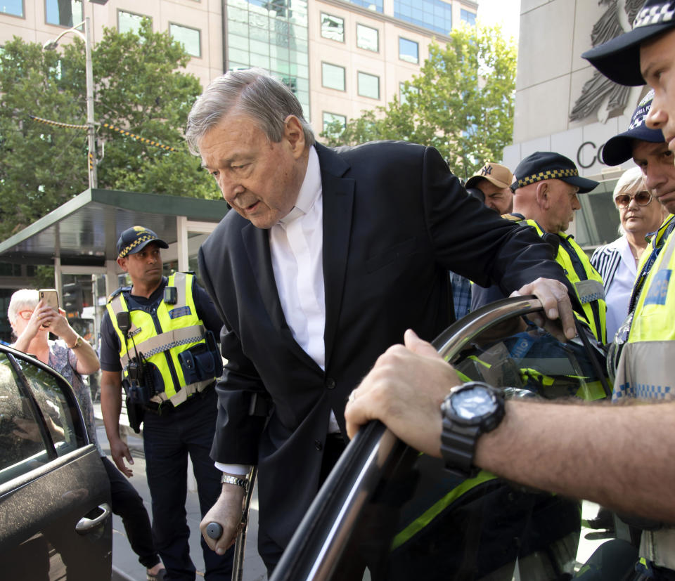 In this Dec. 11, 2018, photo, Cardinal George Pell leaves the County Court in Melbourne, Australia, after his conviction. Pell was sentenced in an Australian court on Wednesday, March 13, 2019 to 6 years in prison for molesting two choirboys in a Melbourne cathedral more than 20 years ago. (AP Photo/Andy Brownbill)