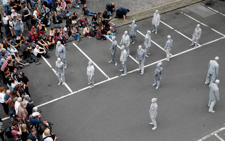 <p>Prostestors dressed-up in grey clothes like Zombies attend an arts performance called ‘1000 Gestalten’ demonstration prior the upcoming G20 summit on July 5, 2017 in Hamburg, northern Germany. (Friedemann Vogel/Getty Images) </p>