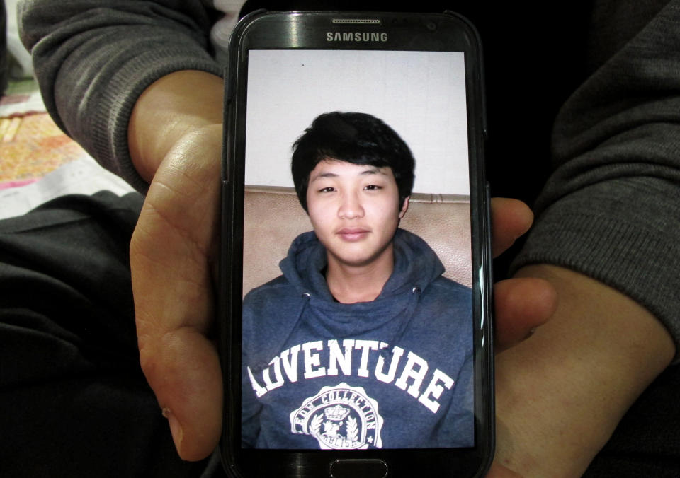 Lee Jong-eui, 48, shows a photo of his nephew Nam Hyun-chul,17, one of missing passengers aboard the ferry Sewol sank off South Korea, during an interview at a gymnasium in Jindo, South Korea Saturday, April 19, 2014. Relatives of about 270 people missing have grown increasingly exasperated and distrusting of South Korean authorities, in part because of confusion, early missteps and perceived foot-dragging. For days, they have dealt with shock, fear and bewilderment. They have briefly been buoyed by new ideas for finding survivors, changes in death counts and the number of missing, even rumors of contact with trapped relatives, only to be let down later. (AP Photo/Gillian Wong)