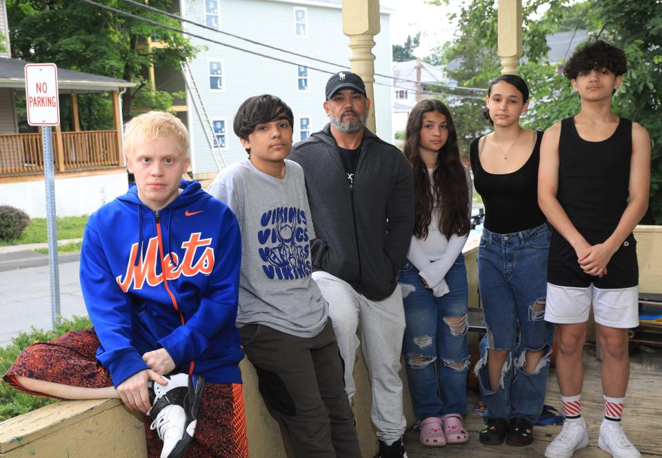 Eric Alvarez and his family outside their home in Walden, N.Y., on June 21, 2022.