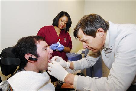 Paralyzed patient Jason Disanto's tongue is pierced in order for him to pilot a wheelchair using the Tongue Drive System at the Shepherd Center in Atlanta, Georgia April 6, 2011. REUTERS/Gary Meek/Shepherd Center/Handout via Reuters