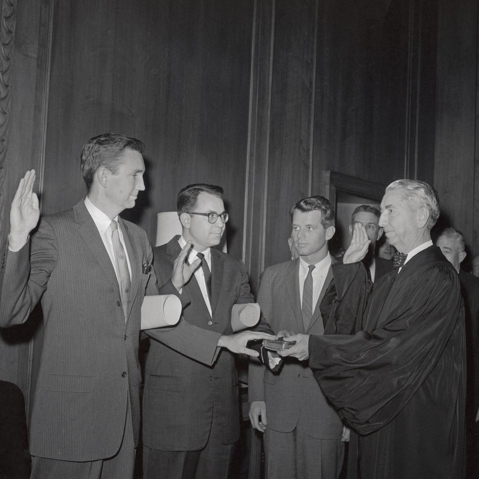 Ramsey Clark (L) being sworn in as US Assistant Attorney General by his father, Supreme Court Justice Tom Clark in 1961 -  Bettmann