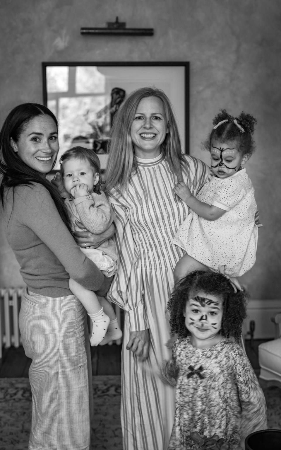 Lilibet being carried by her mother Meghan, posing alongside Misan Harriman