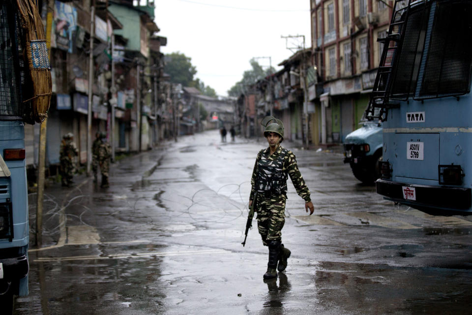 FILE - In this Wednesday, Aug. 14, 2019 file photo, an Indian paramilitary soldier patrols during security lockdown in Srinagar, Indian controlled Kashmir. Frustration, anger and fear have been growing in Kashmir in the five weeks since the Hindu nationalist government of Prime Minister Narendra Modi stripped the region of most of its semiautonomous status on Aug. 5 and imposed a curfew and a communications blackout. Although some restrictions have been eased in the main city of Srinagar, with students encouraged to return to school and businesses to reopen, rural residents complain of what they perceive as a campaign of violence and intimidation that seems designed at suppressing any militancy, rebellion or dissent. (AP Photo/ Dar Yasin, File)